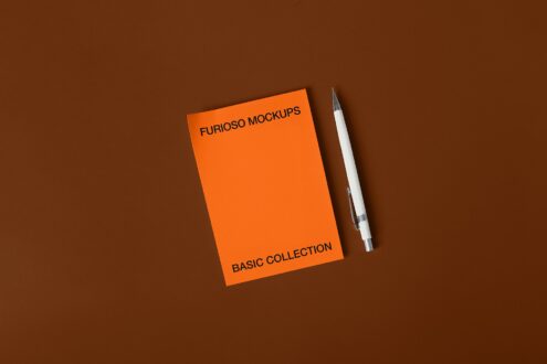 Orange notepad with white pen on brown surface, top left text placement