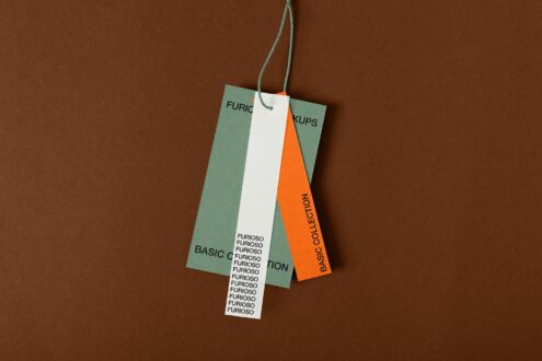Three hanging tags layered together, showcasing green, white, orange color blocks with text placement