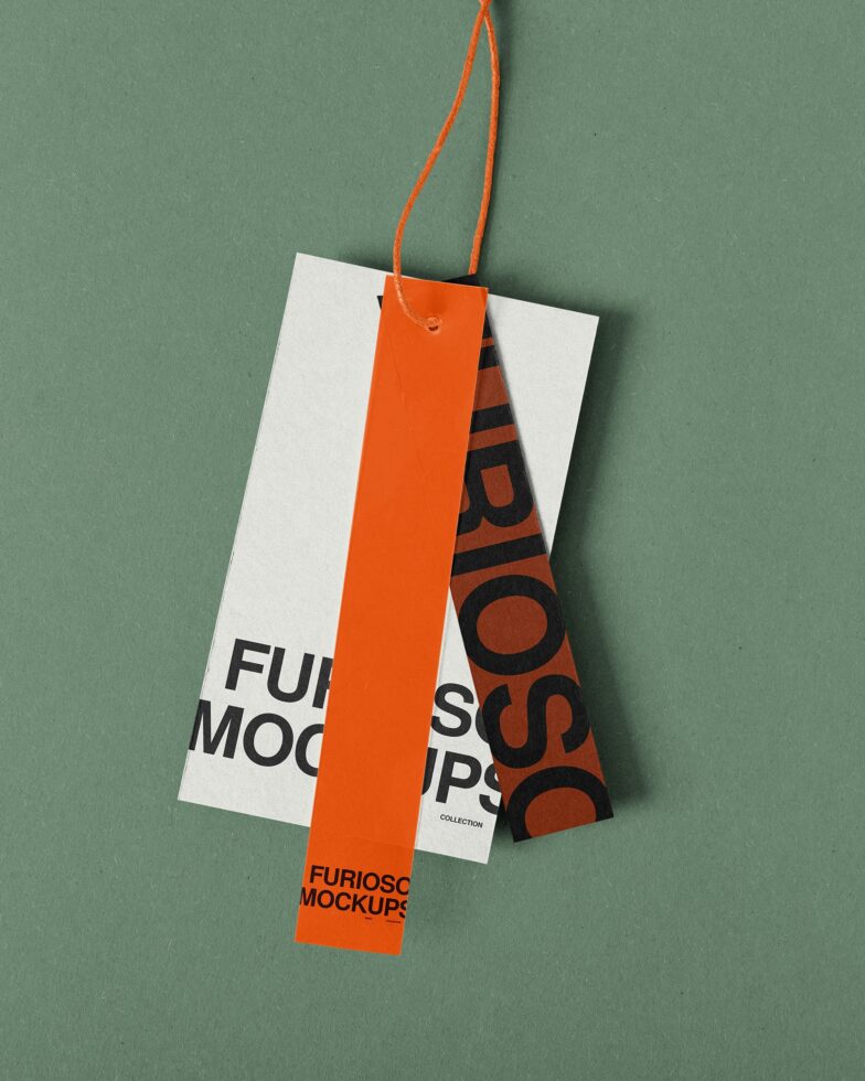 Hanging tag mockup with orange ribbon on green background, white card stock with printed design visible