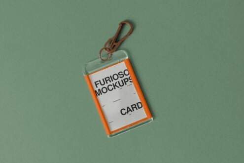 Orange ID card holder with brown carabiner clip on sage green background
