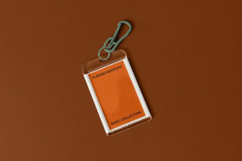 White-framed card holder with mint carabiner clip against warm brown textured surface