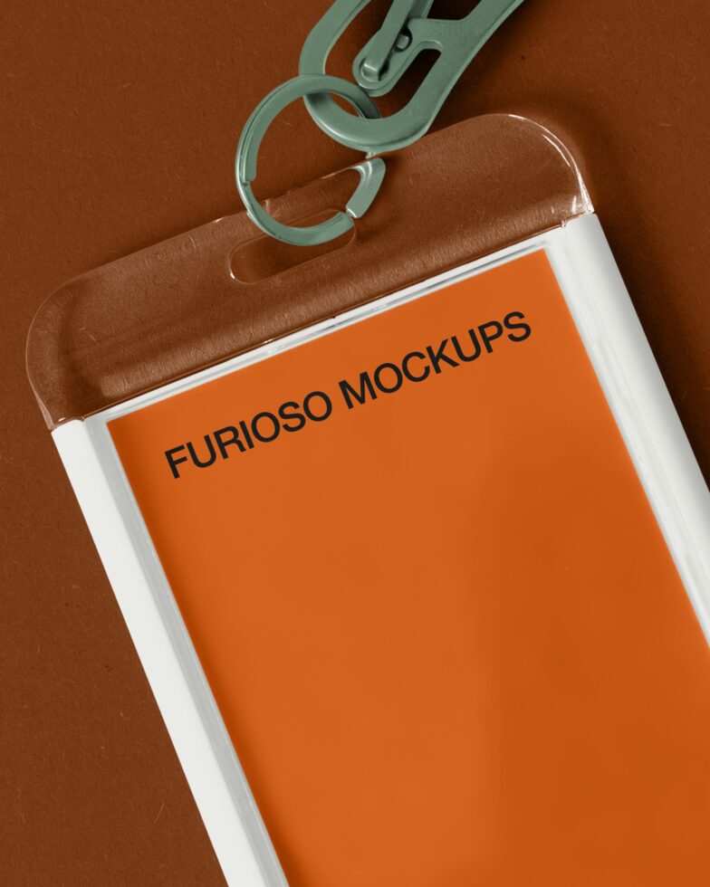 Orange credential holder with mint green clip attachment on brown leather background