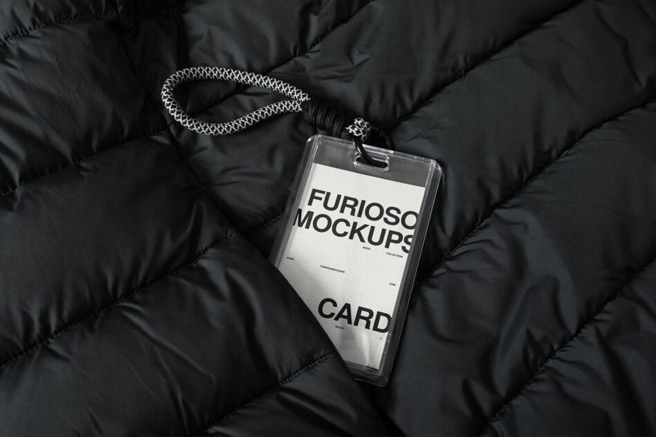Clear lanyard card mockup with white insert on black puffer jacket detail