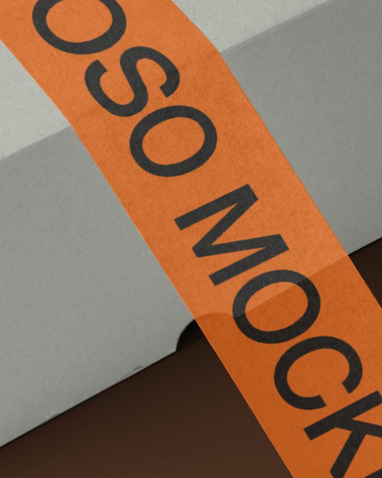 Orange diagonal label strip with black letter spacing showing onomatopoeia across surfaces
