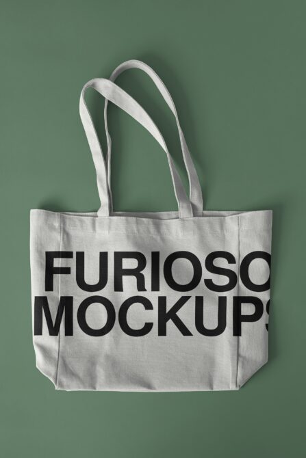 Cream linen tote bag with bold black sans serif text on soft green background