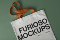 White canvas tote with rust orange handles showing FURIOSO MOCKUPS text