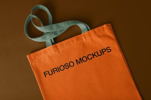 Orange tote with teal handles on brown background showing fabric texture