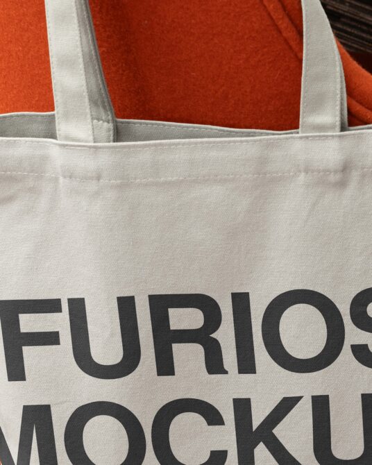 Close up detail of cream tote fabric with bold black Furioso text