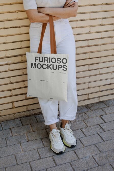 Natural linen tote with brown handles showing Furioso Mockups design on model