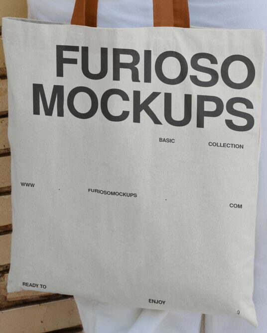 Cream canvas tote bag with brown handles displaying Furioso Mockups branding