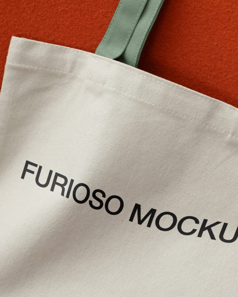 Cream canvas tote bag with Furioso Mockups Basic Collection text on red background