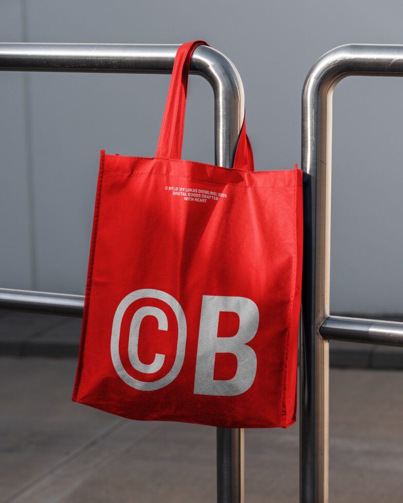 Red tote bag hanging on metal rail displaying reflective silver CB logo
