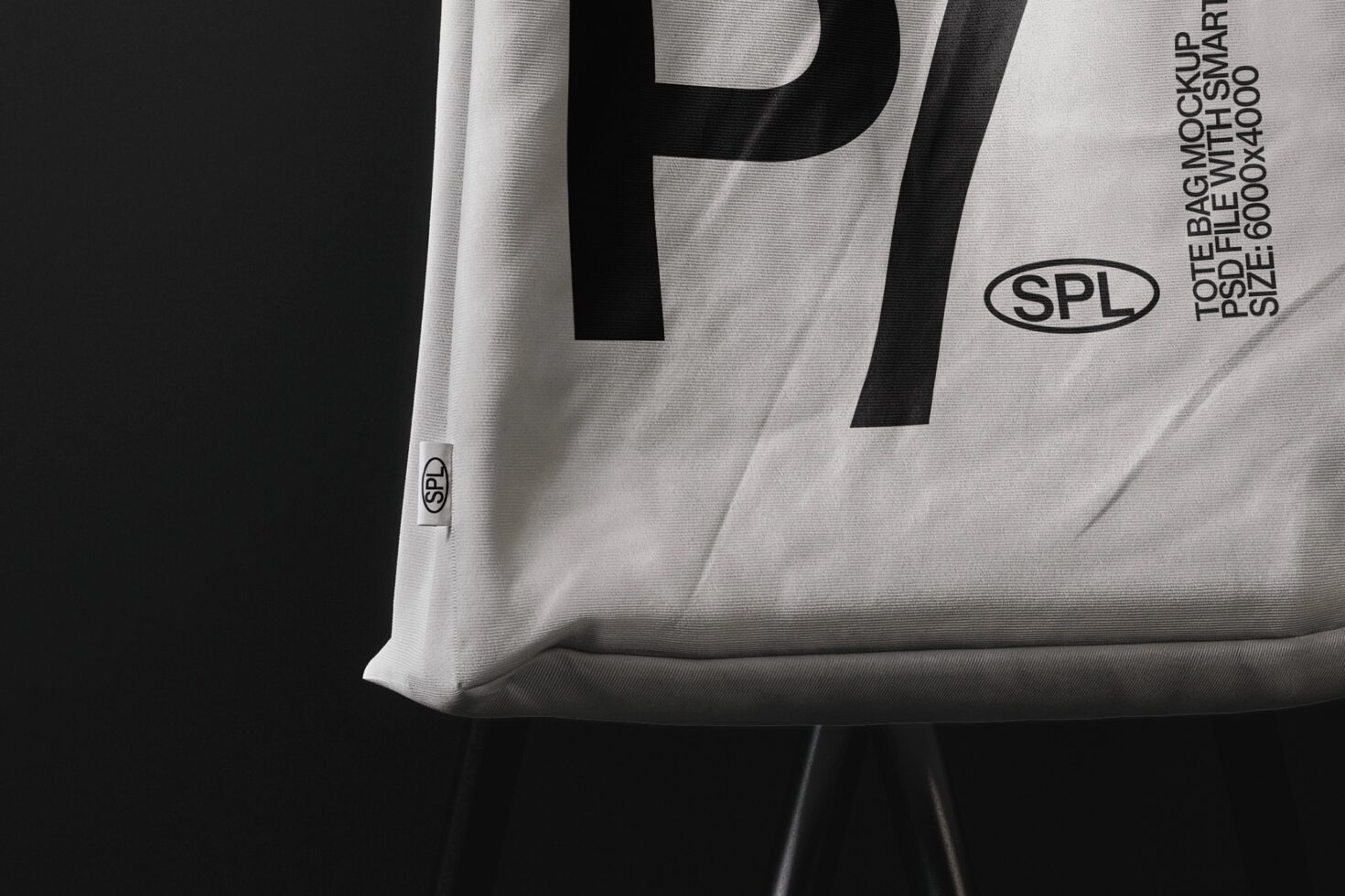 White tote bag mockup with large P letter on black background, side view