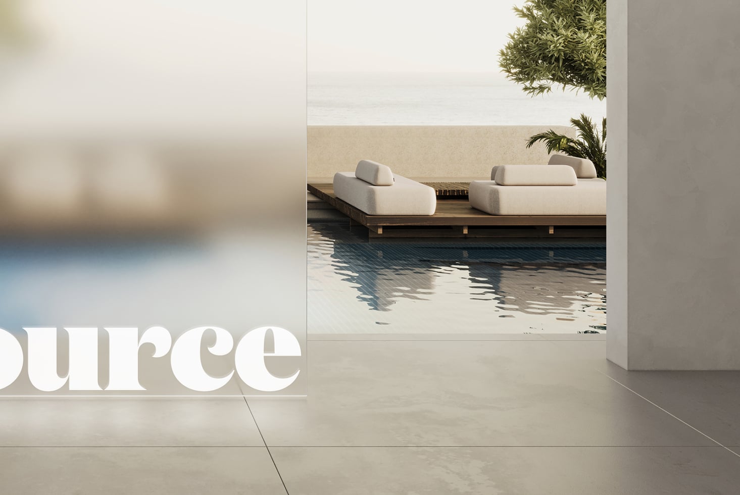 Partial white lettering visible from modern poolside lounge overlooking water view