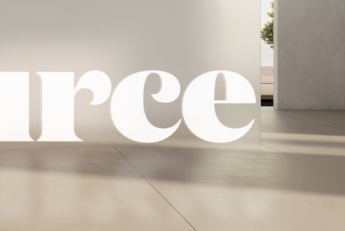 Large white letters with deep shadows in spacious contemporary room with entry