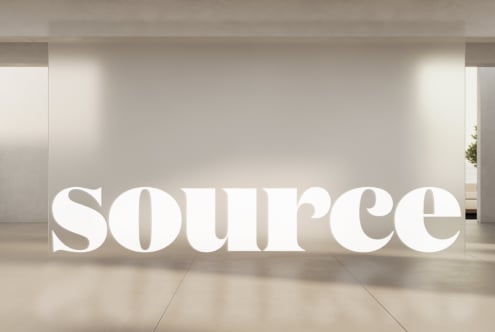 Sculptural white text displayed in clean minimal hallway with side lighting