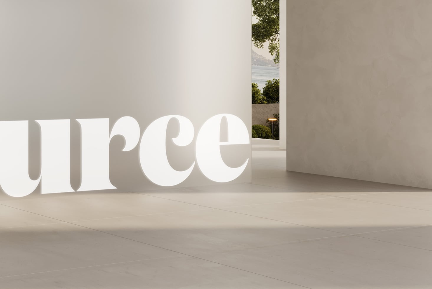 Oversized white serif characters in bright gallery with window overlooking landscape