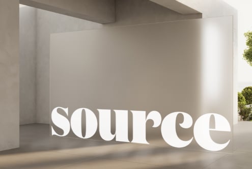 White dimensional lettering installed in minimalist interior space with natural light