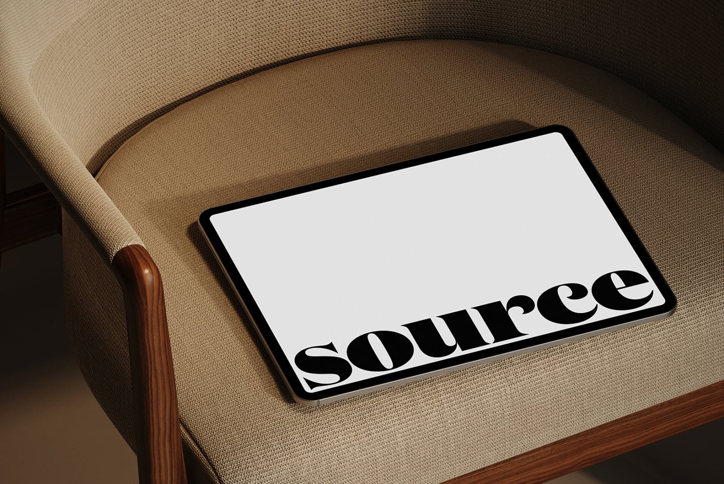 Tablet on cream linen seat with Source text visible at bottom