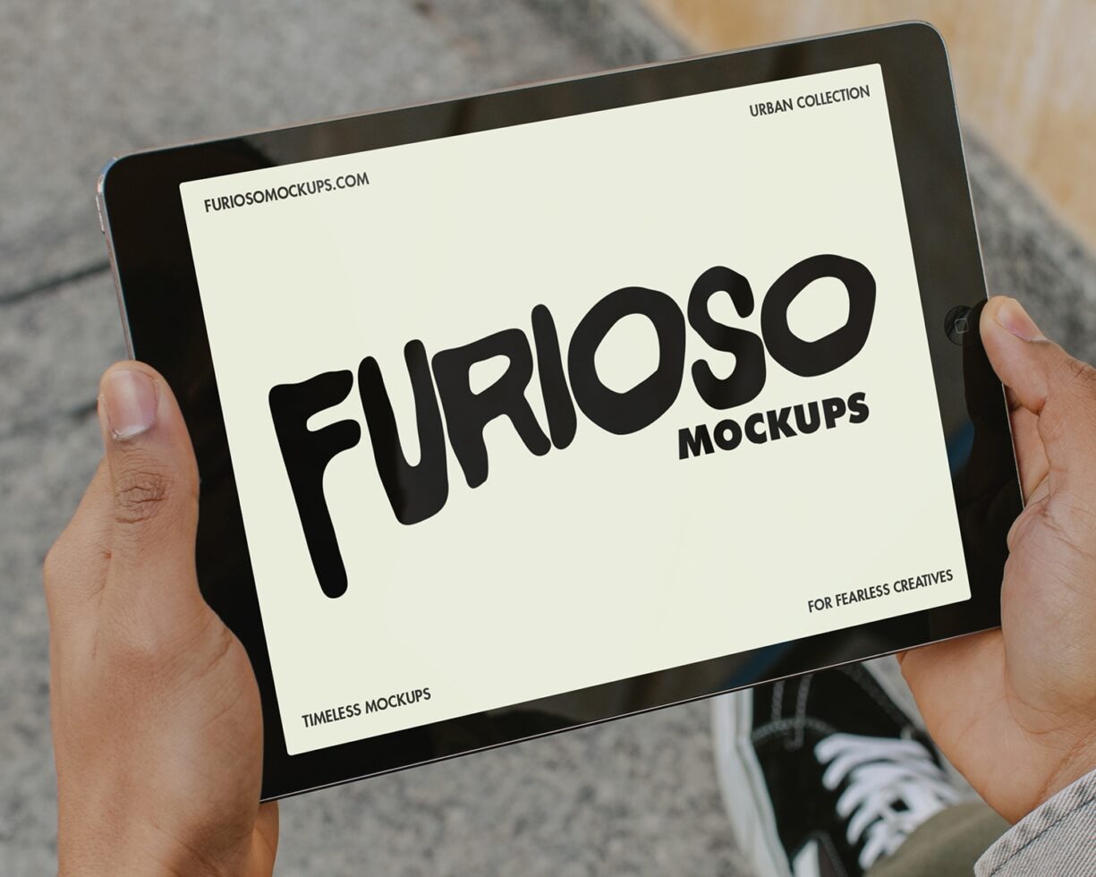 Tablet held up showing cream background with black Furioso mockup design