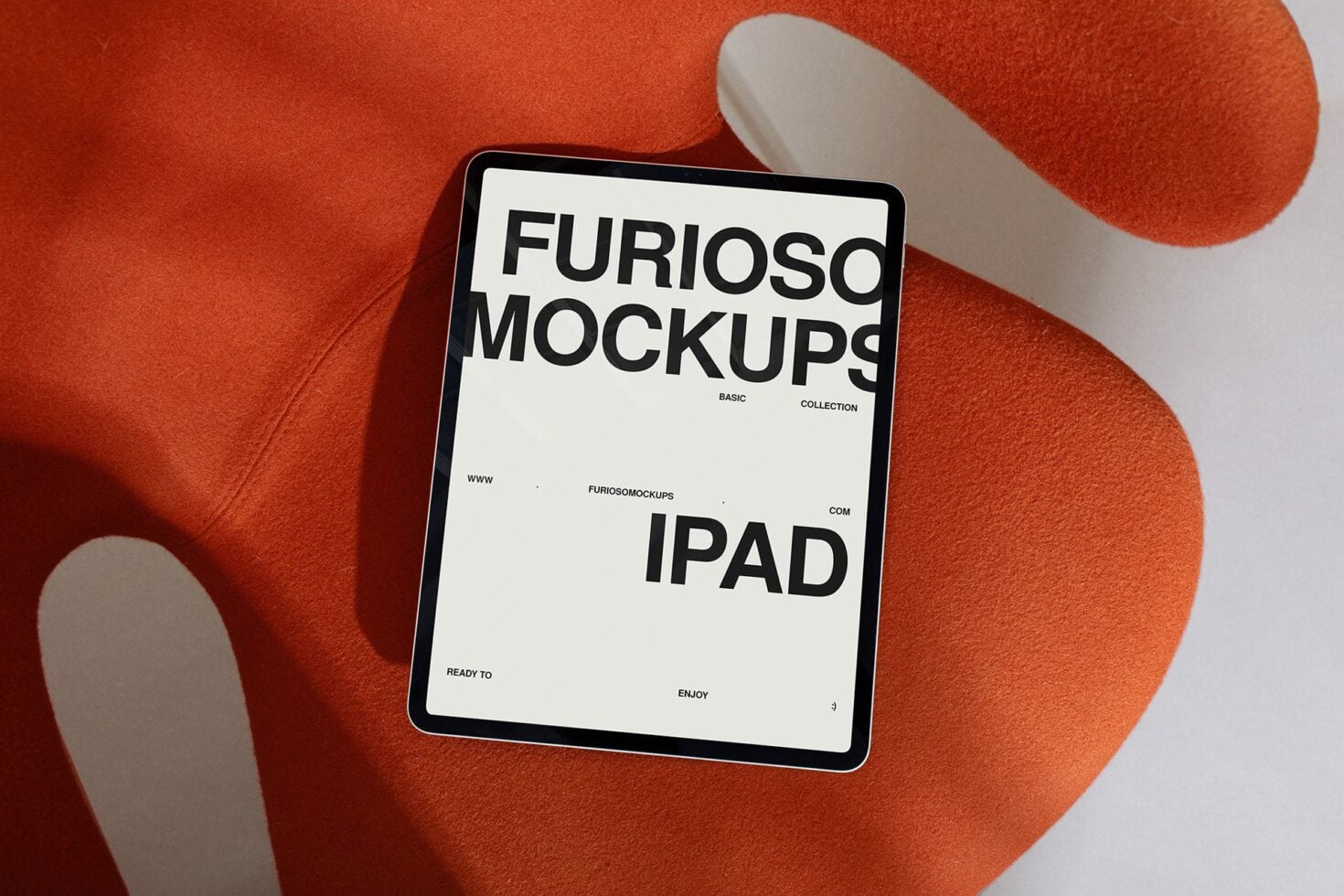 iPad mockup on rust fabric displaying white screen with black text layout
