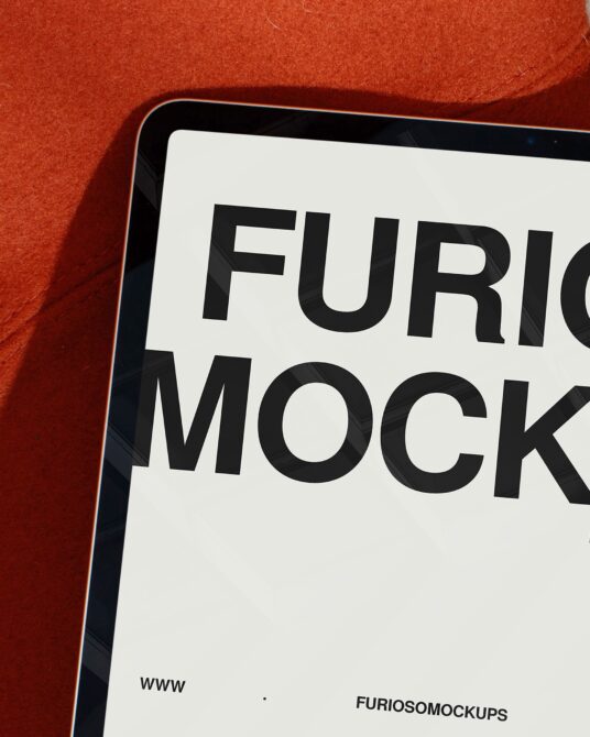 Closeup of tablet screen with black text on white display against red fabric