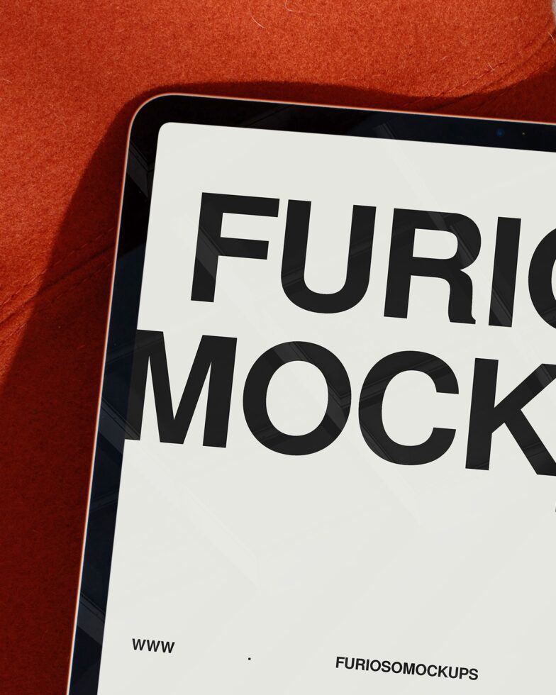Closeup of tablet screen with black text on white display against red fabric
