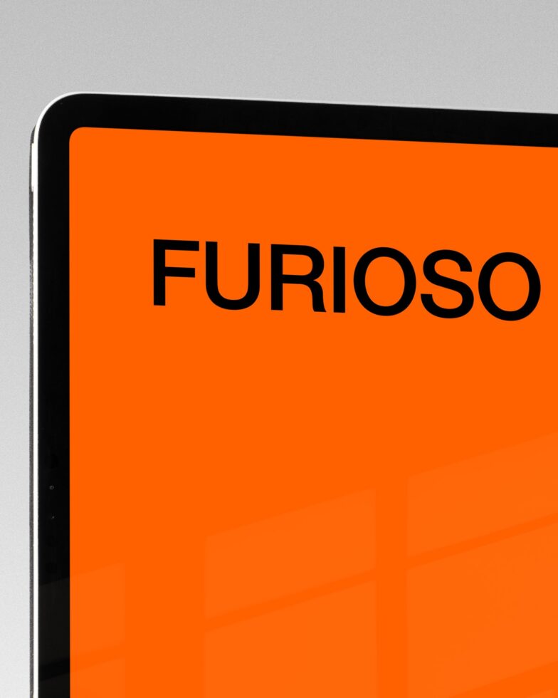 iPad Pro showing bold orange screen with black sans serif text