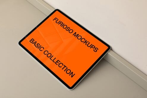 Orange iPad mockup tilted on white surface casting soft shadow