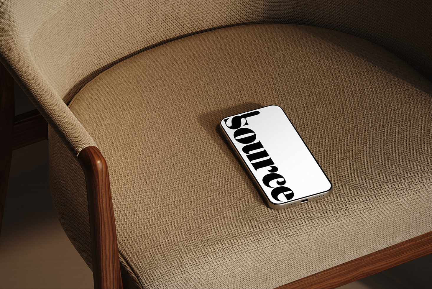 Phone lying on neutral linen sofa seat with wooden arm visible