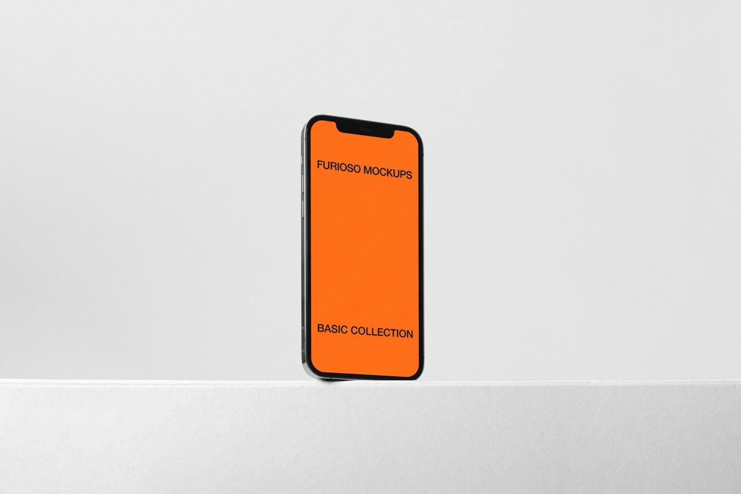 Smartphone standing upright showing orange mockup on white surface