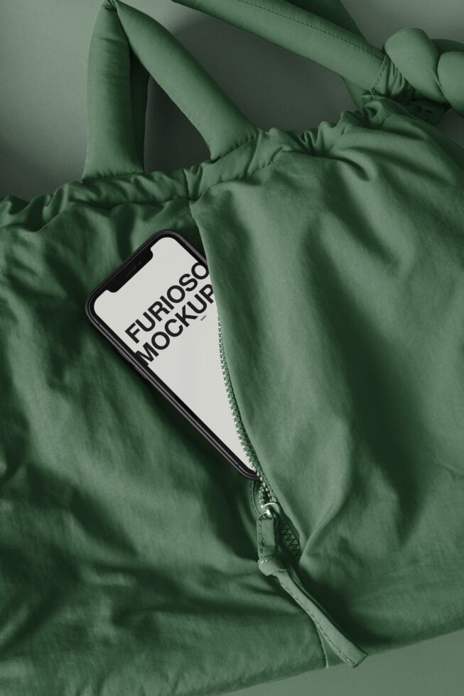 Sage green puffy jacket with phone in pocket showing mockup display