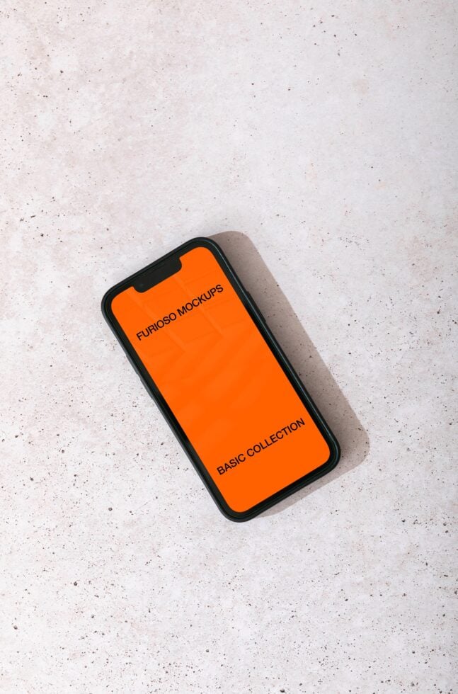 Overhead shot of iPhone with black case showing bright orange display mockup