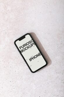 iPhone mockup with cream screen displaying black text on speckled surface