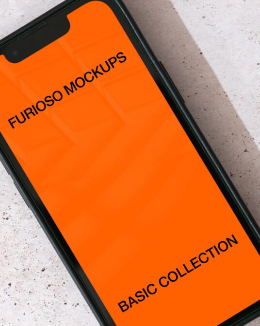 Black smartphone with notch displaying orange screen mockup on concrete