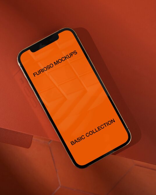 iPhone mockup with bright orange screen on terracotta background casting shadow
