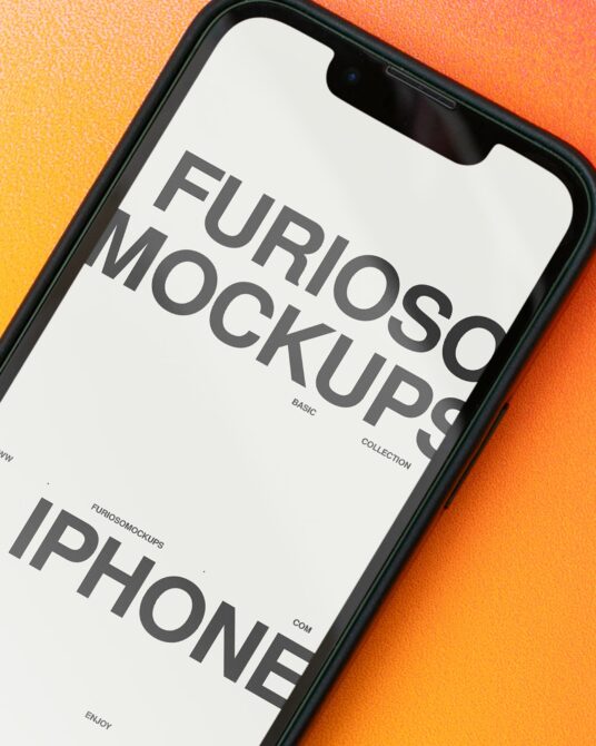 Close-up of iPhone screen on vibrant orange gradient background displaying mockup text