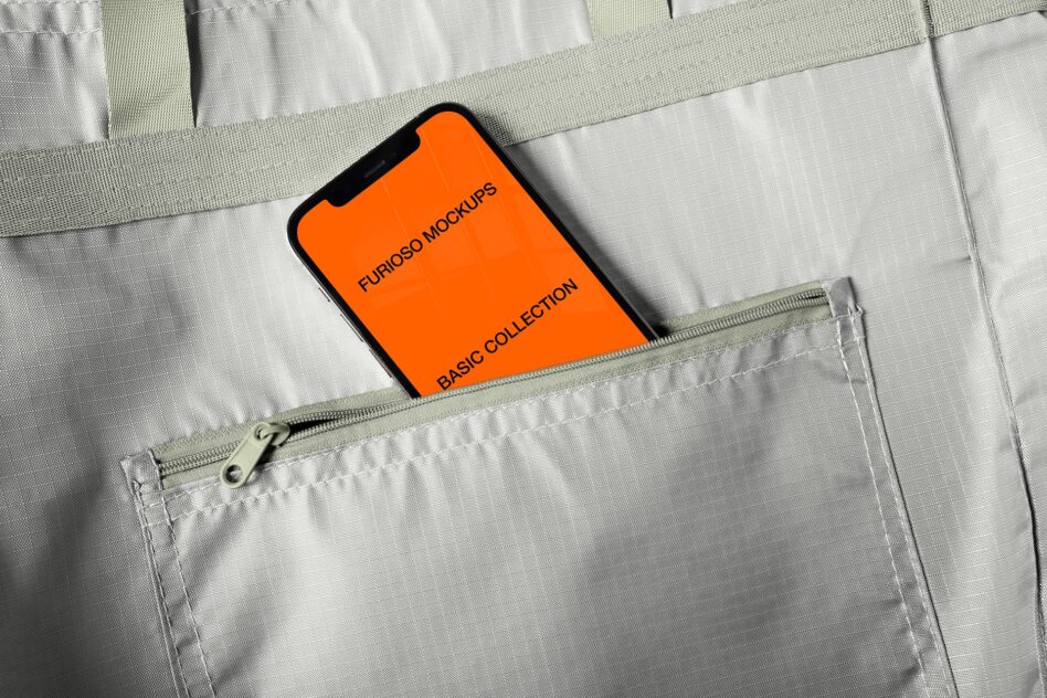 Orange iPhone mockup peeking out of light gray zippered bag pocket