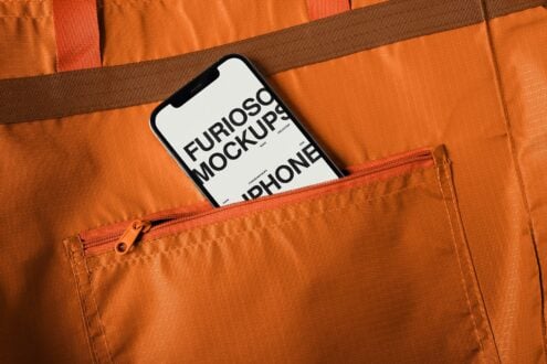 White iPhone mockup tucked inside bright orange backpack front pocket