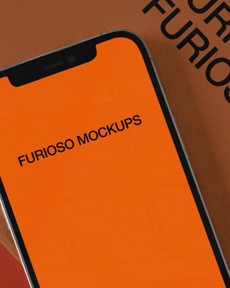 Smartphone screen showing bright orange interface on textured surface