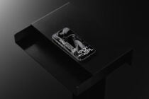 Phone showing abstract black liquid imagery on dark surface setup