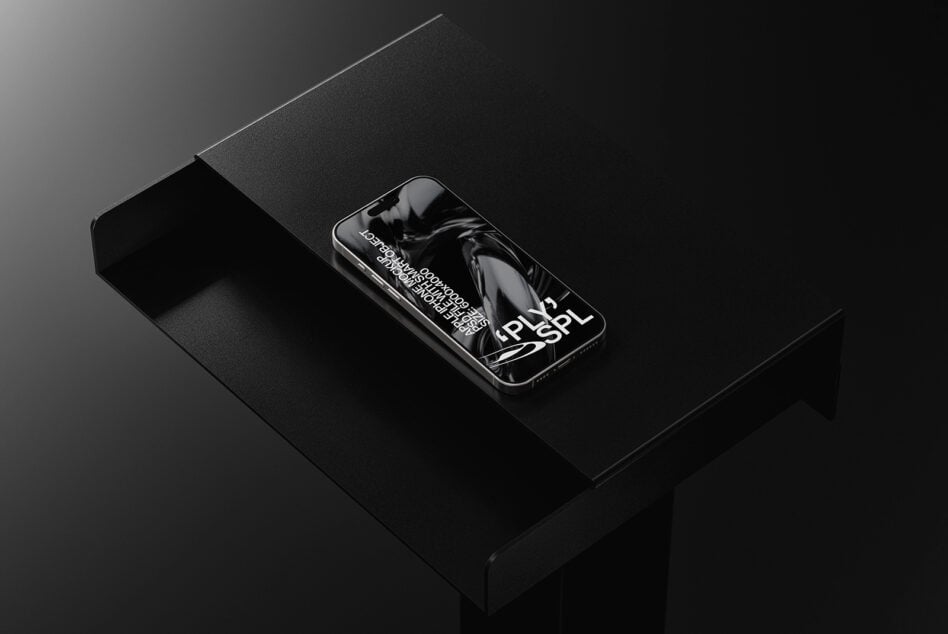 Phone showing abstract black liquid imagery on dark surface setup