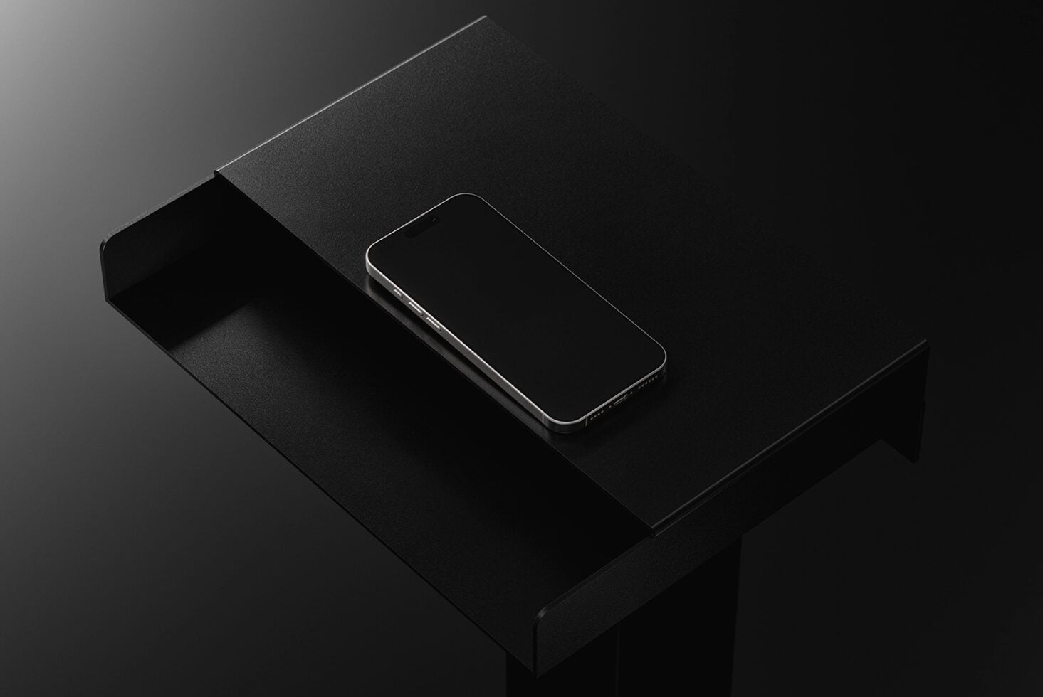 Blank phone screen sitting on dark fabric background with edge visible