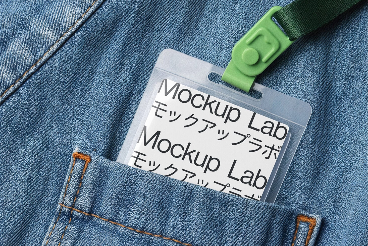 Clear ID badge with green strap attached to light blue denim jacket