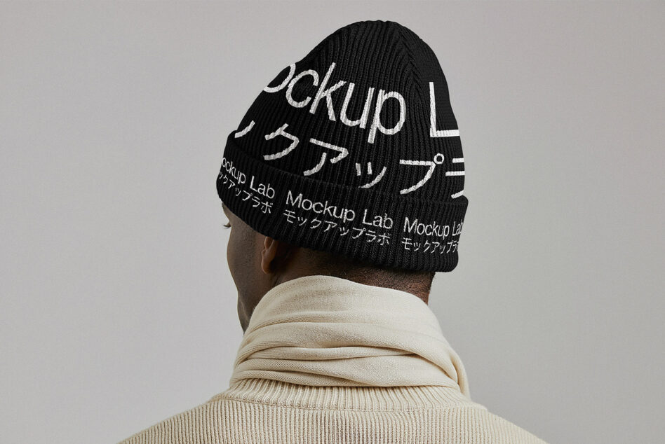 Back view of person in cream turtleneck wearing all black knit beanie