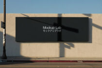 Black billboard mockup on urban street wall with shadow overlay
