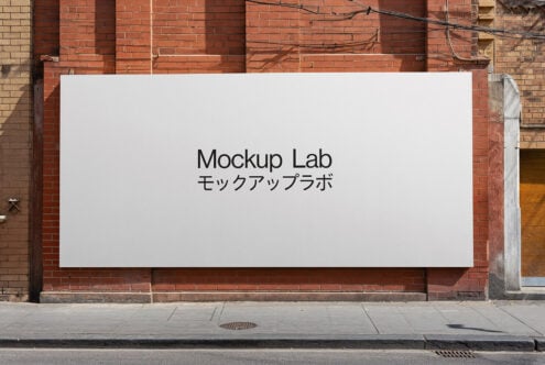 White rectangular billboard on red brick wall with Mockup Lab bilingual text