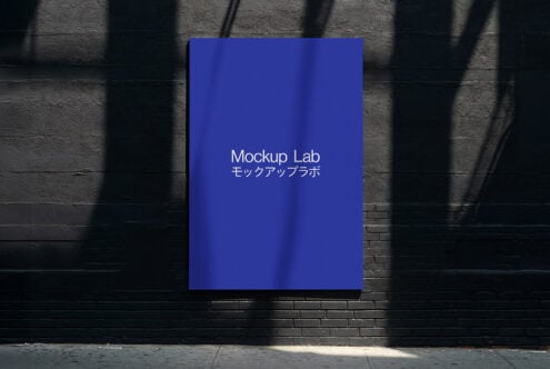 Vertical sign on dark wall glowing deep blue with window shade shadows