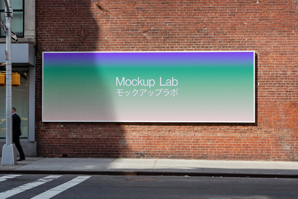 Horizontal sign on brick wall showing gradient from purple to teal to white