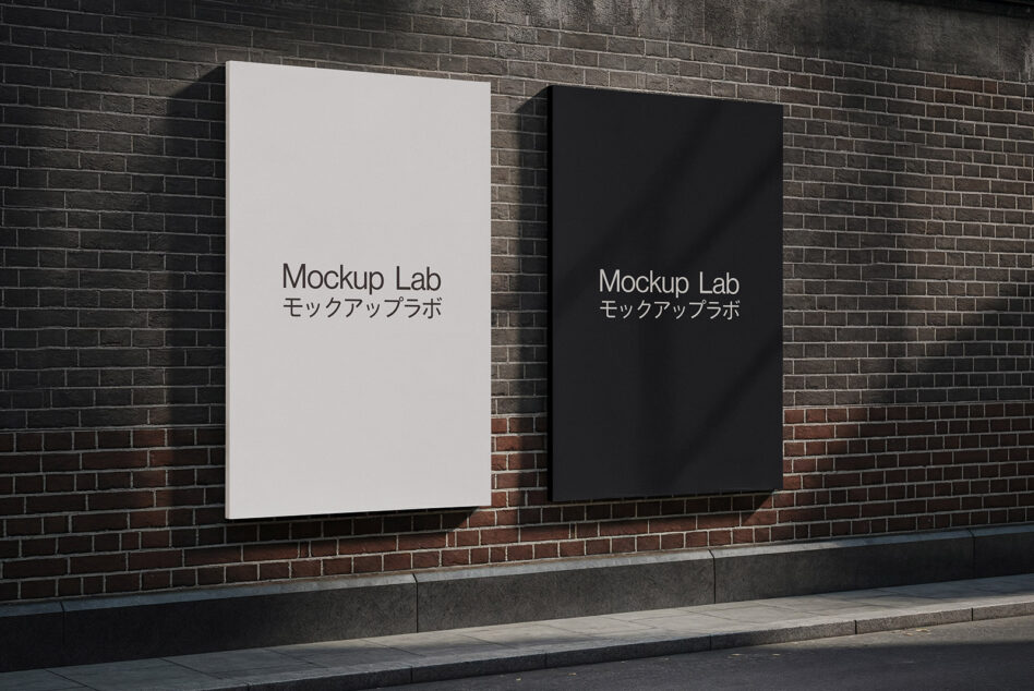Pair of mounted posters on brick wall, one off-white left, one black right